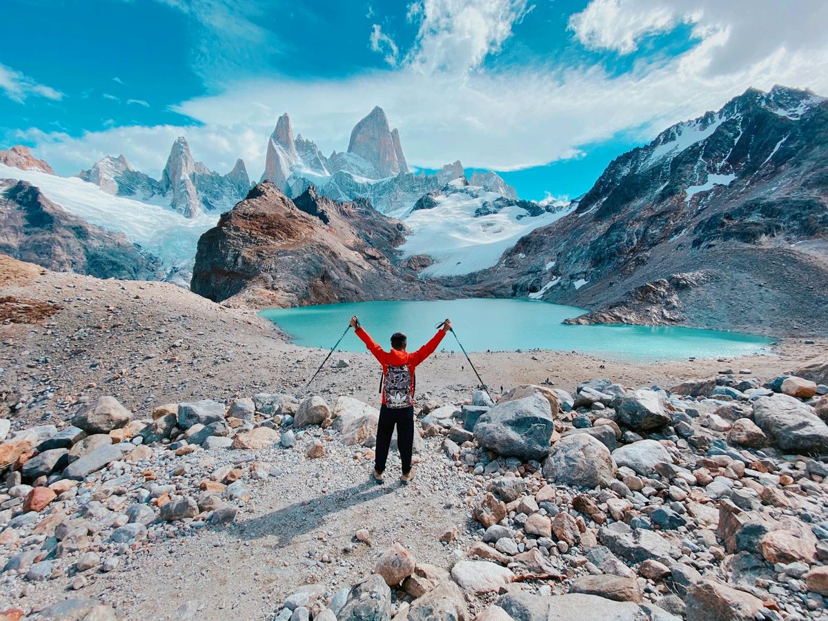 back view of a man standing with his arms spread in laguna de los tres argentina