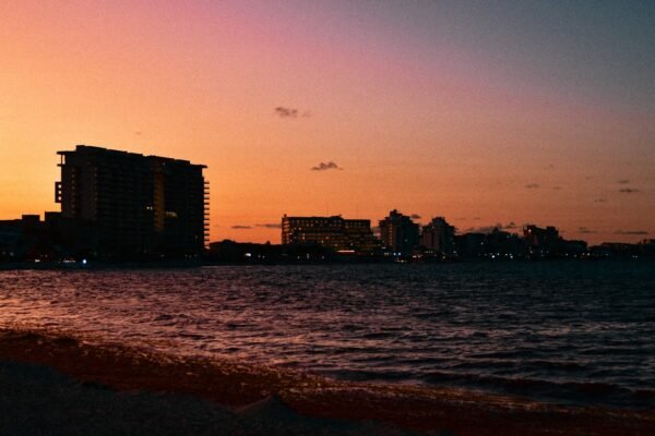 a view of a body of water with buildings in the background