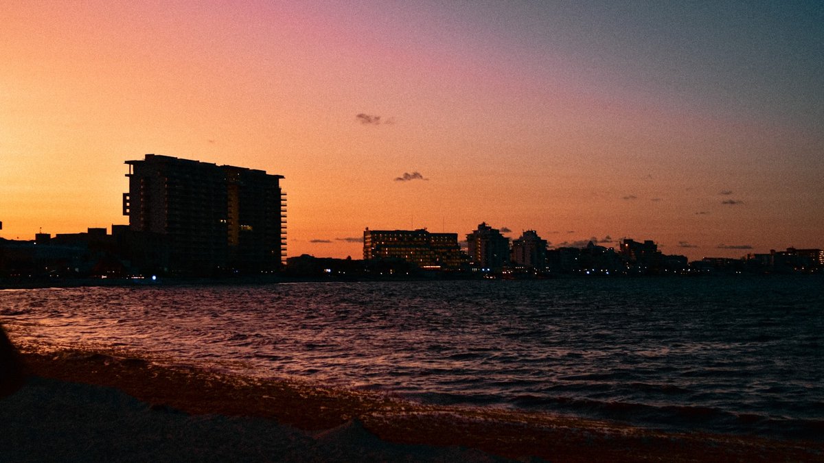 a view of a body of water with buildings in the background