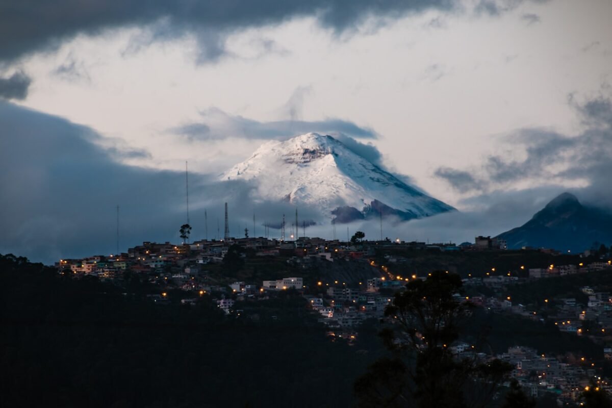 town with lights far from mountain field with snow