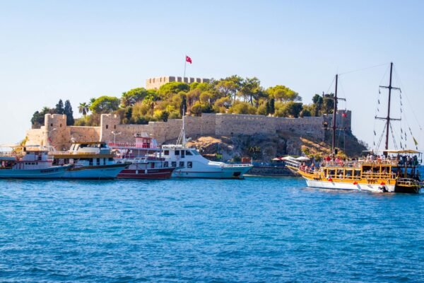 ferries near island with castle